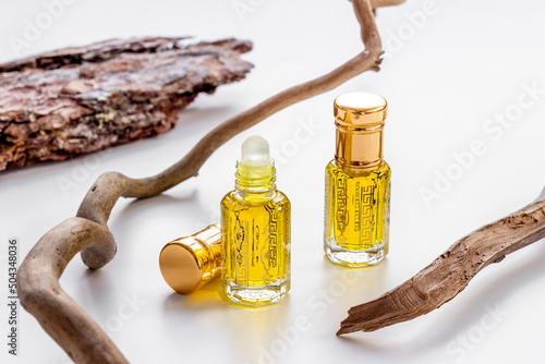 Bottles of agarwood tree oil perfume, close up. Traditional Arabian fragrance photo