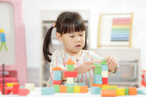  young girl playing creative toy blocks for homeschooling