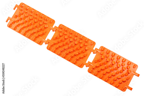 Foto orange plastic foldable emergency traction pads isolated on white background, us