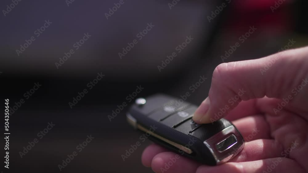 Person opens the trunk of the car with a remote access key. Close-up. Travel by car, logistics 4K 10 BIT Person opens the trunk of the car with a remote access key. Close-up. Travel by car, logistics 4K 10 BIT