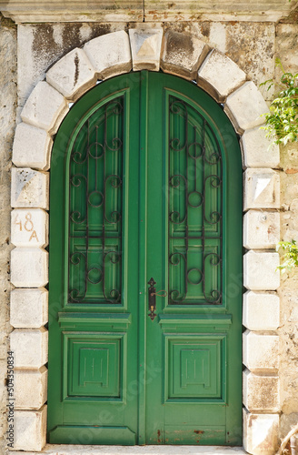 Green old textured door in a stone wall  Rovinj  Croatia  Europe 