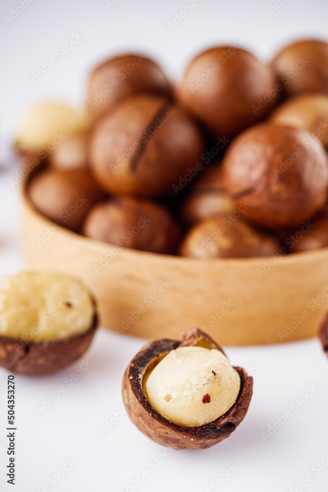 fresh macadamia nuts on a white acrylic background fresh macadamia nuts on a white acrylic background