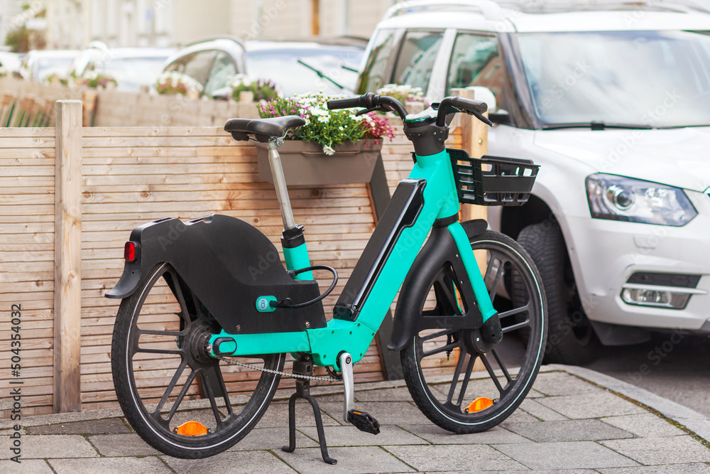 Bike Rent in City Street. Bicycle sharing service. Electric bike in urban  environment. Stock-Foto | Adobe Stock