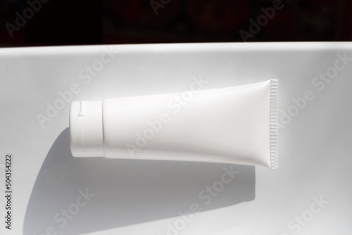 clean white tube of moisturizer on white background