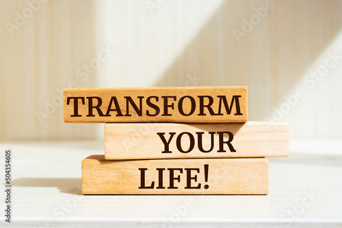Wooden blocks with words 'Transform your life'.