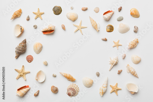Summer time concept Flat lay composition with beautiful starfish and sea shells on colored table, top view with copy space for text