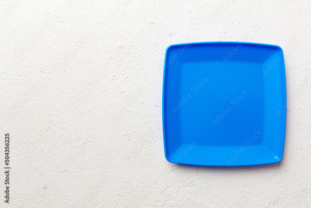 Top view of empty square plate on cement background. Empty space for your design Top view of empty square plate on cement background. Empty space for your design