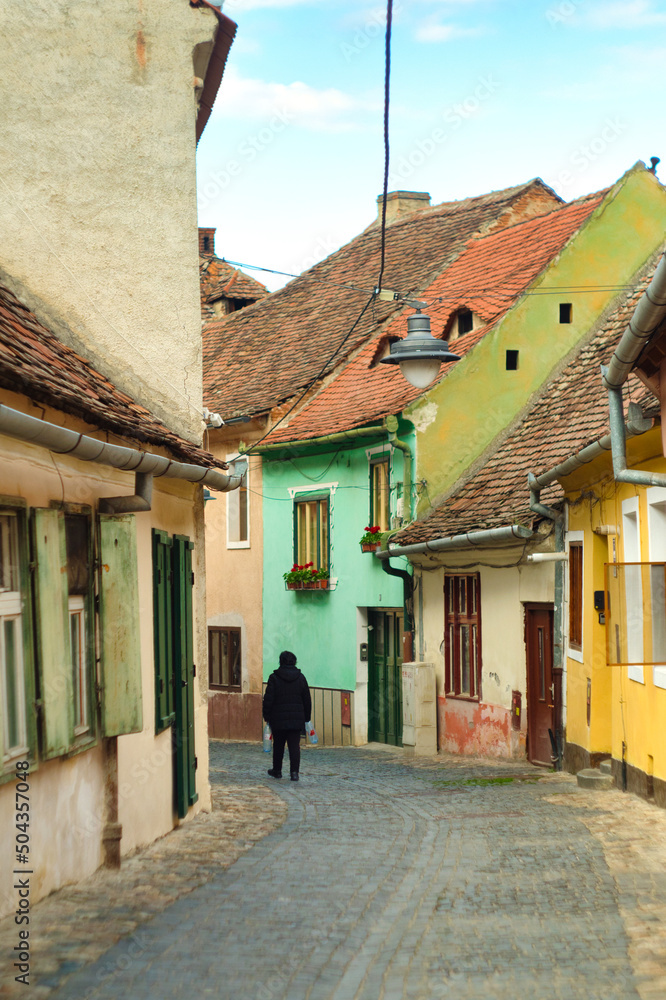 Medieval street and facade of historic buildings in city center of Sibiu Romania