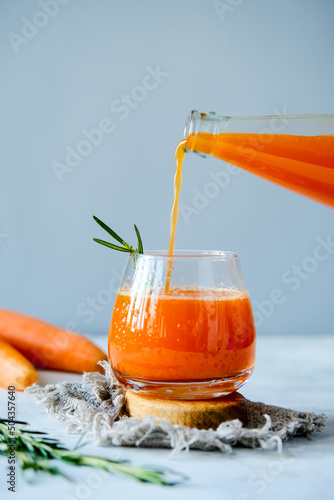 Carrot juice in a glassy glass. Freshly lived carrot juice. Orange carrot juice. Vegetable juice