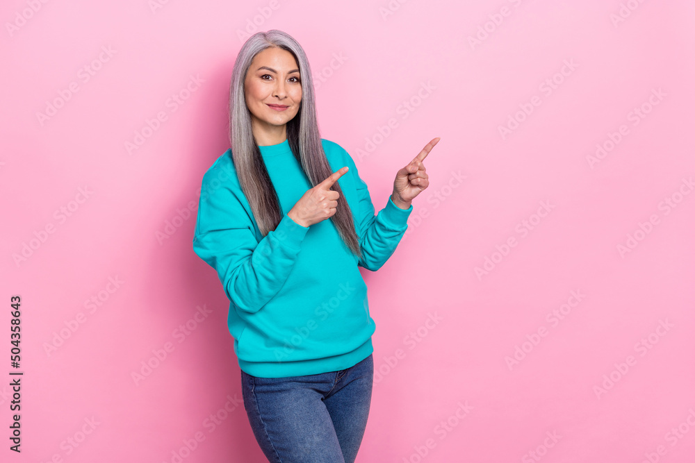 Photo of pretty positive person direct fingers empty space proposition isolated on pink color background Photo of pretty positive person direct fingers empty space proposition isolated on pink color background
