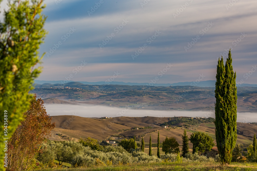Misty foggy morning view from the mountain hills of Tuscany, Italy