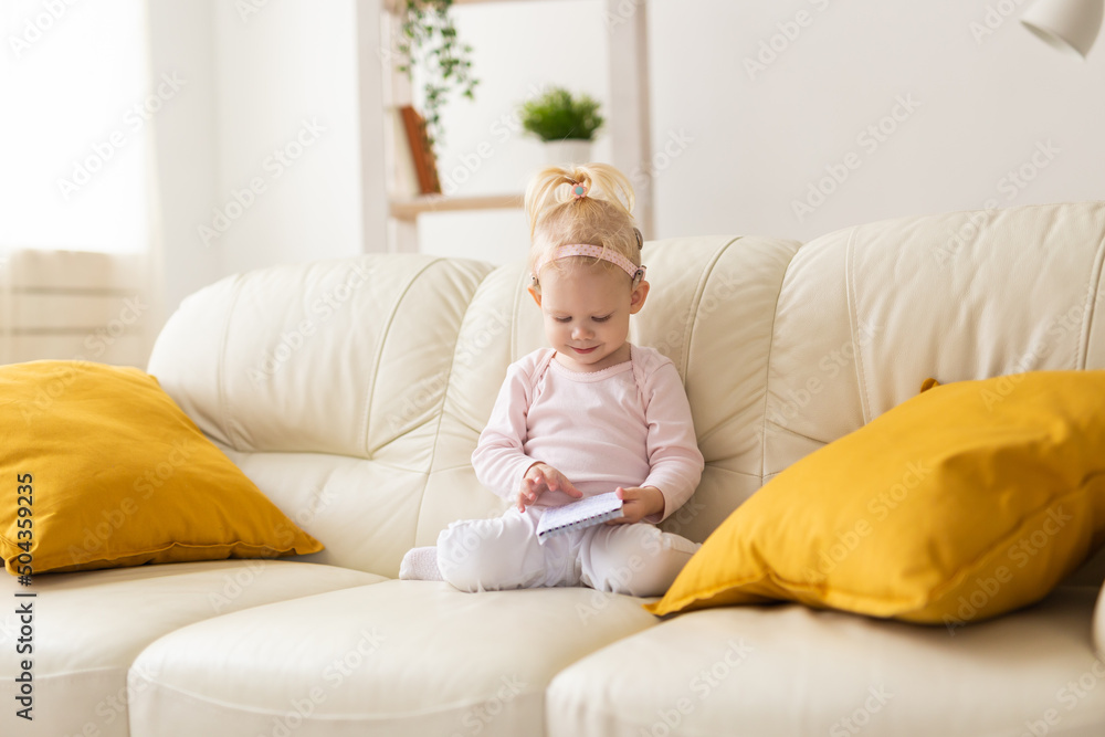 Baby with cochlear implants at home. Deafness and medical technology concept. Baby with cochlear implants at home. Deafness and medical technology concept.