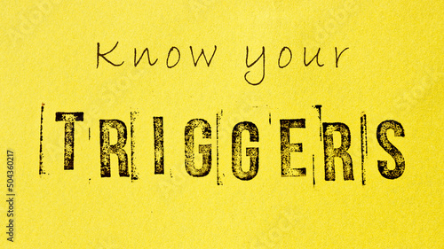 Know your triggers sign message on yellow background. Mental triggering and self-awareness concept.