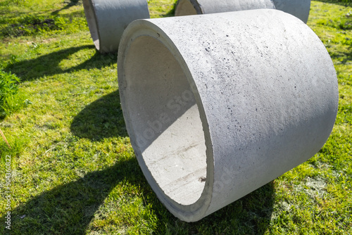 White concrete rings lay on green grass