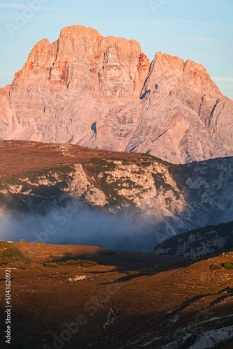 the mountains during sunrise in the natural park Tre Cime - Sesto Dolomites, near the town of Cortina d'ampezzo, Veneto, Italy - October 2021.