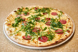 Pizza with salami, cheese and herbs is ready to eat. Cooking pizza
