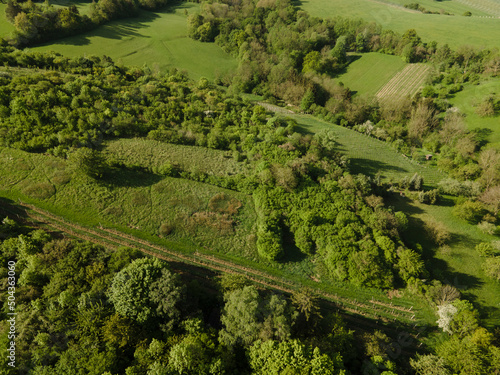 aerial drone flight over green meadows and forest in lower austria