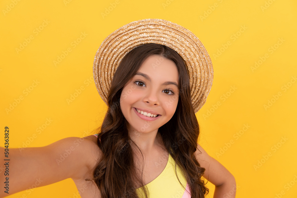 happy kid in summer straw hat making selfie on yellow background, selfie time happy kid in summer straw hat making selfie on yellow background, selfie time