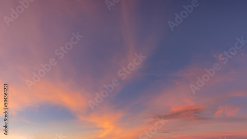 Pink orange sky with clouds at sunset as natural background.