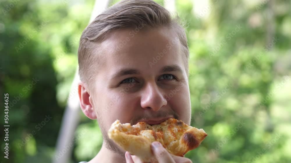 Caucasian man eating pizza. Hungry man taking a bite from pizza. Close up. Caucasian man eating pizza. Hungry man taking a bite from pizza. Close up.