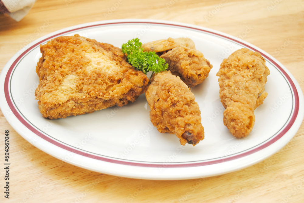 Fried Chicken Pieces Served on a White Plate Fried Chicken Pieces Served on a White Plate