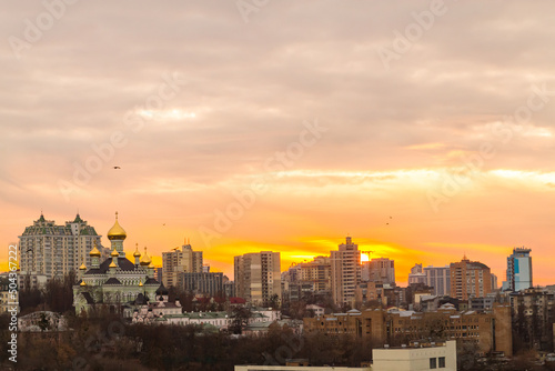 Ukraine, Kyiv – November 26, 2016: Aerial panoramic view on central part of Kyiv city, residential area at sunset. Stunning sunset, golden hour. Lukianivska area. City silhouettes. 