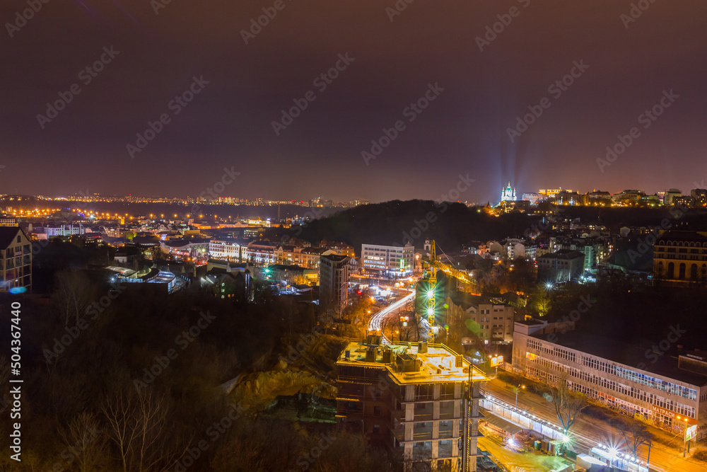 Ukraine, Kyiv – November 26, 2016: Aerial panoramic view on central and historical part of Kyiv city, residential area in the evening. St Andrew's Church, Podil area.