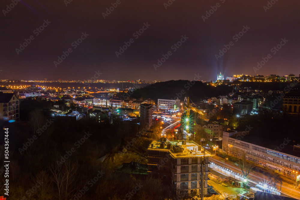 Ukraine, Kyiv – November 26, 2016: Aerial panoramic view on central and historical part of Kyiv city, residential area in the evening. St Andrew's Church, Podil area.