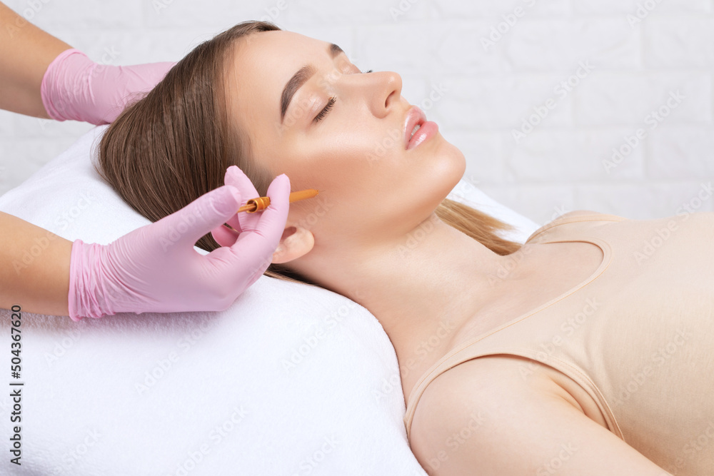 Cosmetologist makes rejuvenating anti wrinkle injections on the face of a beautiful woman. Female aesthetic cosmetology in a beauty salon. Cosmetologist makes rejuvenating anti wrinkle injections on the face of a beautiful woman. Female aesthetic cosmetology in a beauty salon.