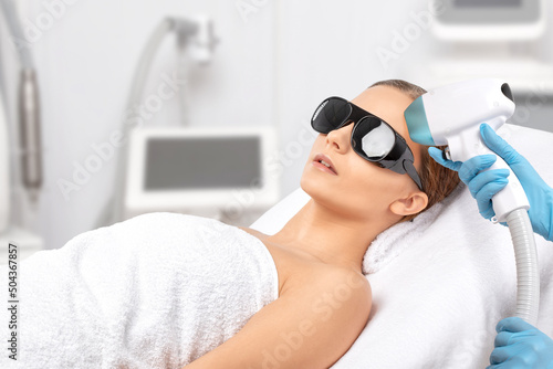 Elos epilation hair removal procedure on the face of a woman. Beautician doing laser rejuvenation in a beauty salon. Facial skin care. Hardware ipl cosmetology