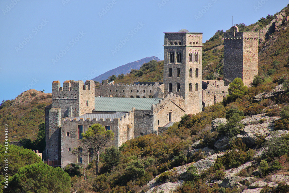 The romanesque monastery of Sant Pere de Rodes with its bell tower on a mountain slope in Catalonia, Spain