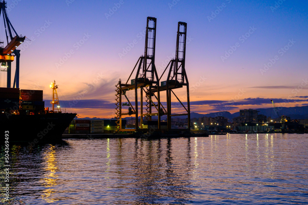 Cranes in Harbor during Sunset Cranes in Harbor during Sunset