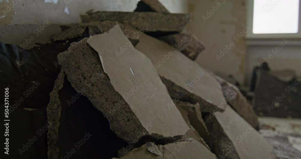 Pile of floor screed leaning against a wall in an empty room. House getting stripped down. Camera panning slowly to the right. Pile of floor screed leaning against a wall in an empty room. House getting stripped down. Camera panning slowly to the right.