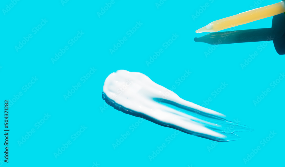 Pipette with dose of fluid hyaluronic acid on blue background. cosmetic concept. flat lay. Pipette with dose of fluid hyaluronic acid on blue background. cosmetic concept. flat lay.
