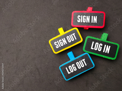 Colored wooden board with the word Sign in,Sign out,Log in,Log out on black background.