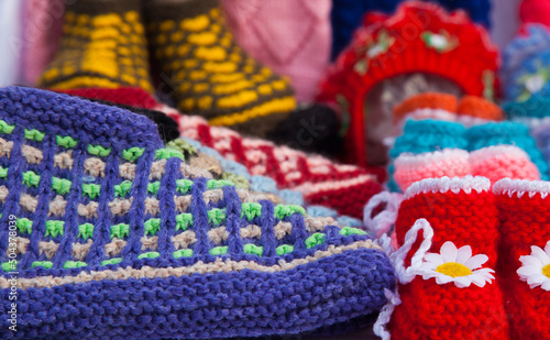 Handmade multi-colored knitted things close-up. © Сергей Жмурчак