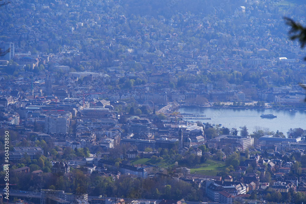 Panoramic view over City of Zurich with lake Zurich seen from local mountain Uetliberg on a summer day morning. Photo taken April 14th, 2022, Zurich, Switzerland.