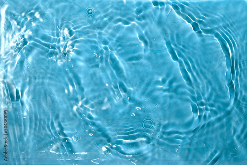 Blue Water splash texture. Sunshine rippled surface perfect for swimming pool spa marketing