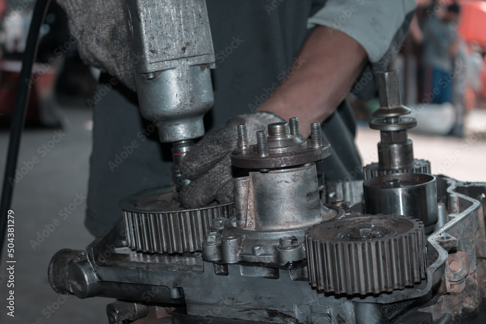 The mechanic is checking the engine. The mechanic is checking the engine.