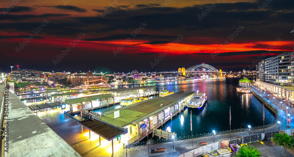 Panoramic night view of Sydney Harbour and CBD buildings on the foreshore in NSW Australia