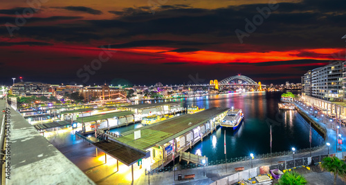 Panoramic night view of Sydney Harbour and CBD buildings on the foreshore in NSW Australia © Elias Bitar