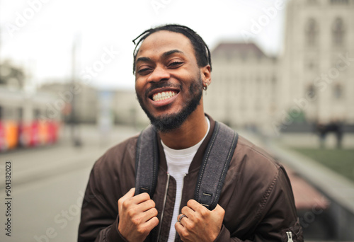 Canvas Print portrait of a smiling young man in the street