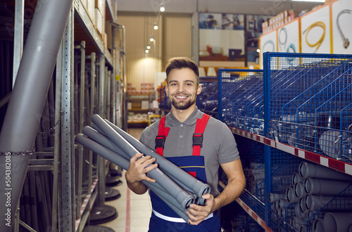 Canvas Print Happy man who works as a salesman at a hardware store where you can buy good qua
