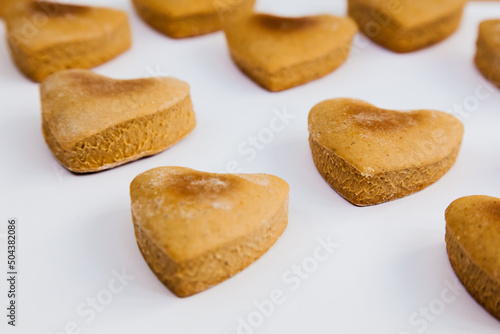 Heart shaped homemade cookies on a white background.