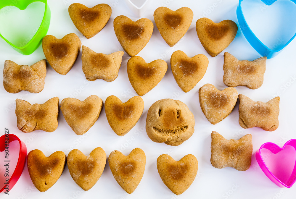 Heart shaped cookies on a white background with plastic shapes. Heart shaped cookies on a white background with plastic shapes.