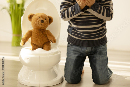 Little toddler child, boy, pee in his pants while playing with toys, child distracted and forget to go to the toilet