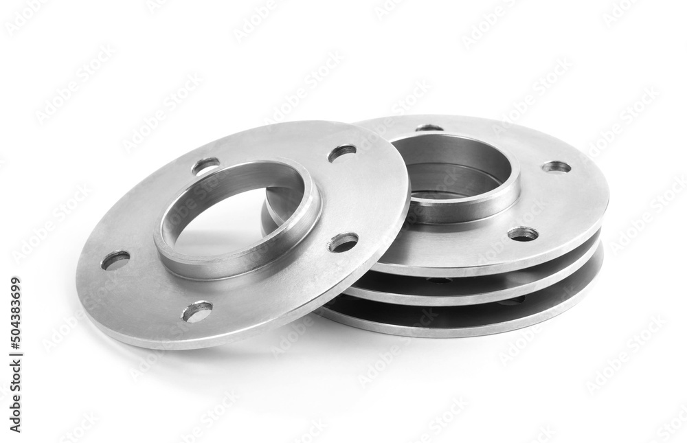 Aluminum wheel spacers. Four through spacers. Isolated on a white background Aluminum wheel spacers. Four through spacers. Isolated on a white background