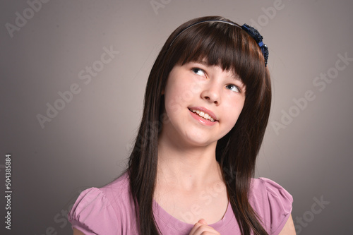 Girl with dark hair posing in studio