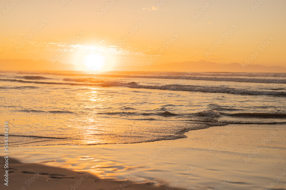 Scenic view of sun shining and reflecting on seascape against sky during sunset, copy space