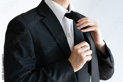 A man wearing a tie for a funeral
